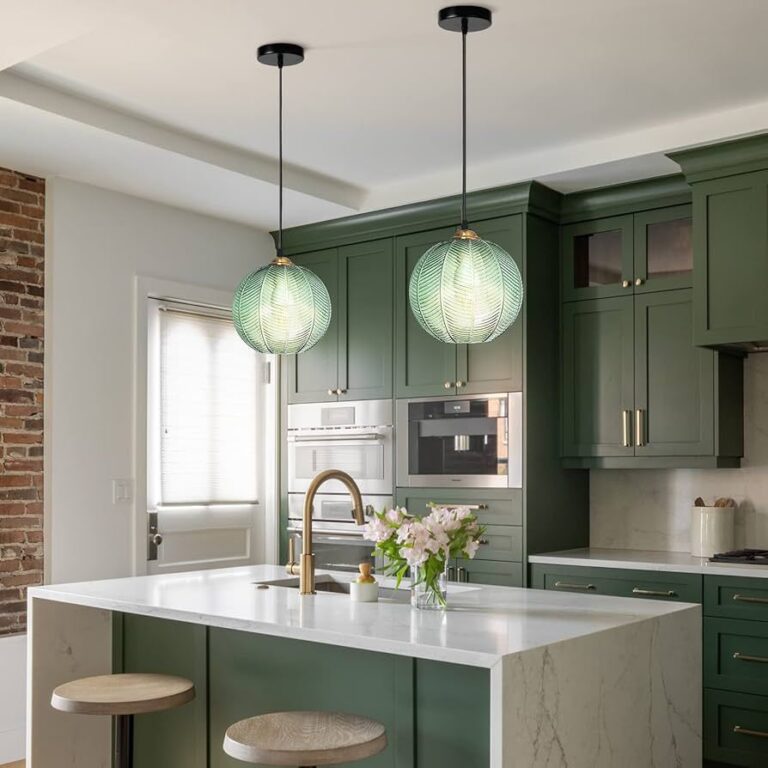 Isla de cocina con lámparas flotantes modernas sobre la encimera, creando un ambiente elegante y funcional